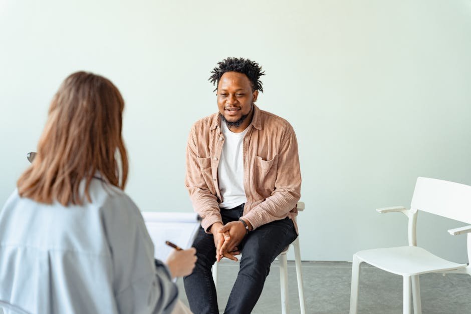 Mental health professional providing psychological first aid to a survivor in a quiet room