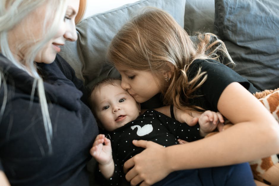 Family members sitting together quietly in a living room offering presence and support after a traumatic event