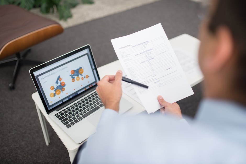 Application paperwork and laptop showing Medicaid enrollment portal