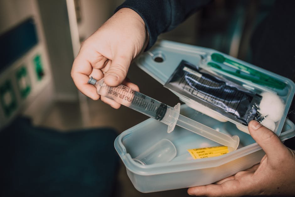 Nurse preparing home medication kit with pill organizer and CIWA assessment sheet