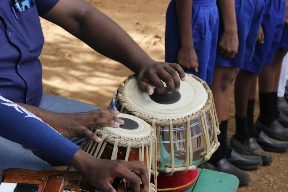 Group of adults playing hand drums together in a circle during a therapy session