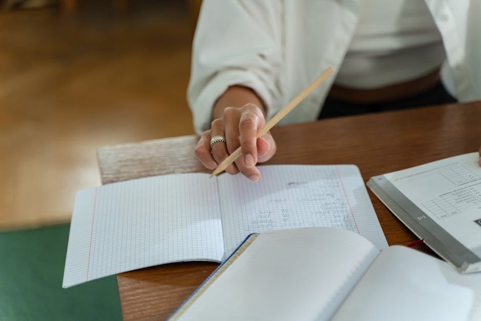 Reader making notes in a CBT workbook with a highlighter and pen on a sofa