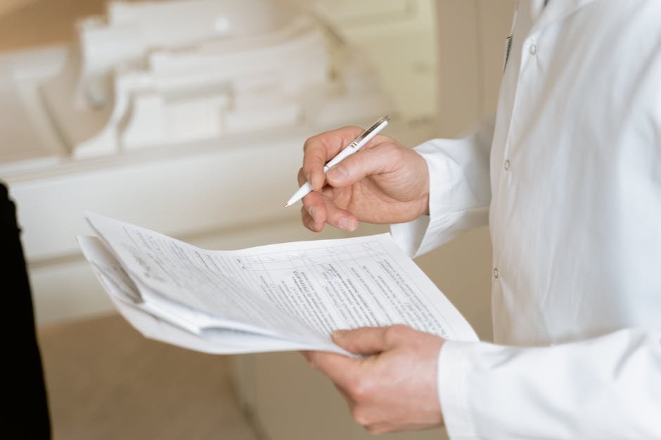 Stack of clinical documentation forms and ICD-10 code reference