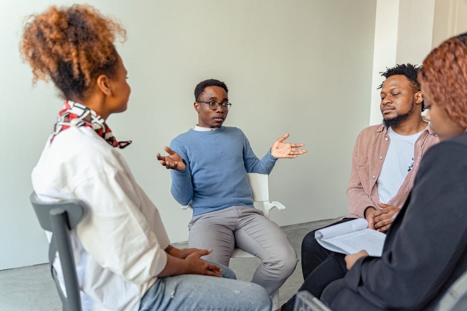 Healthcare professionals in group therapy session at specialized treatment facility