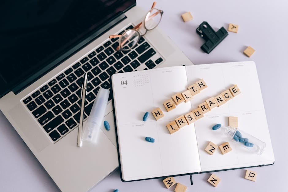 Therapist's notebook and pen beside an insurance brochure