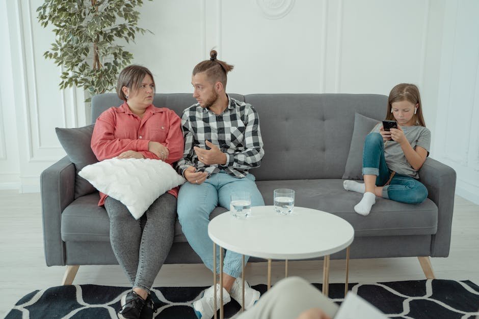 Family therapy session with parents and adolescent child working through communication patterns