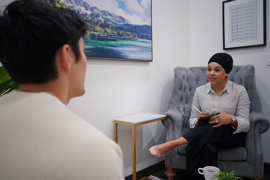 Therapy session with two people sitting in comfortable chairs