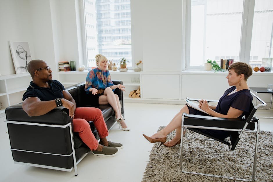 Adult man sitting in therapist office discussing childhood trauma during EMDR session